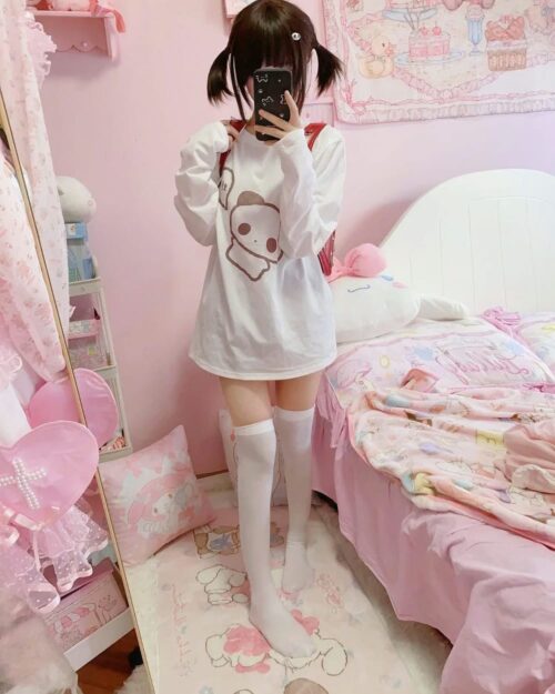 Panda print t-shirt worn by a person in a pink bedroom setting.