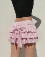 Pink ruffled coquette aesthetic skirt with bow closure.