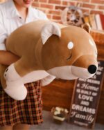 Large brown lazy shiba plushie toy with stitched details and a smiling face.