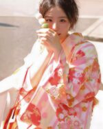 A woman wearing a pink japanese yukata with floral pattern, Japanese aesthetic.