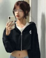 Model wearing a black korean aesthetic hoodie and glasses.