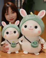 Two kawaii bunny plushies, Cotton the Adventurous Rabbit, wearing green hats and whimsical accessories. Aesthetic rabbit toy.