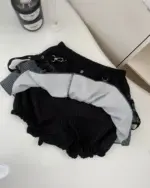 Dark gyaru set featuring a black ruffled top and striped shorts, gothic lolita aesthetic.