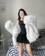White fluffy puffy hooded coat worn by a person, winter fashion.