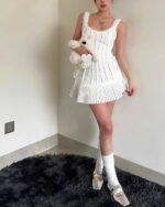 White pleated tied dress, coquette aesthetic dress, featuring a fitted bodice and skirt.