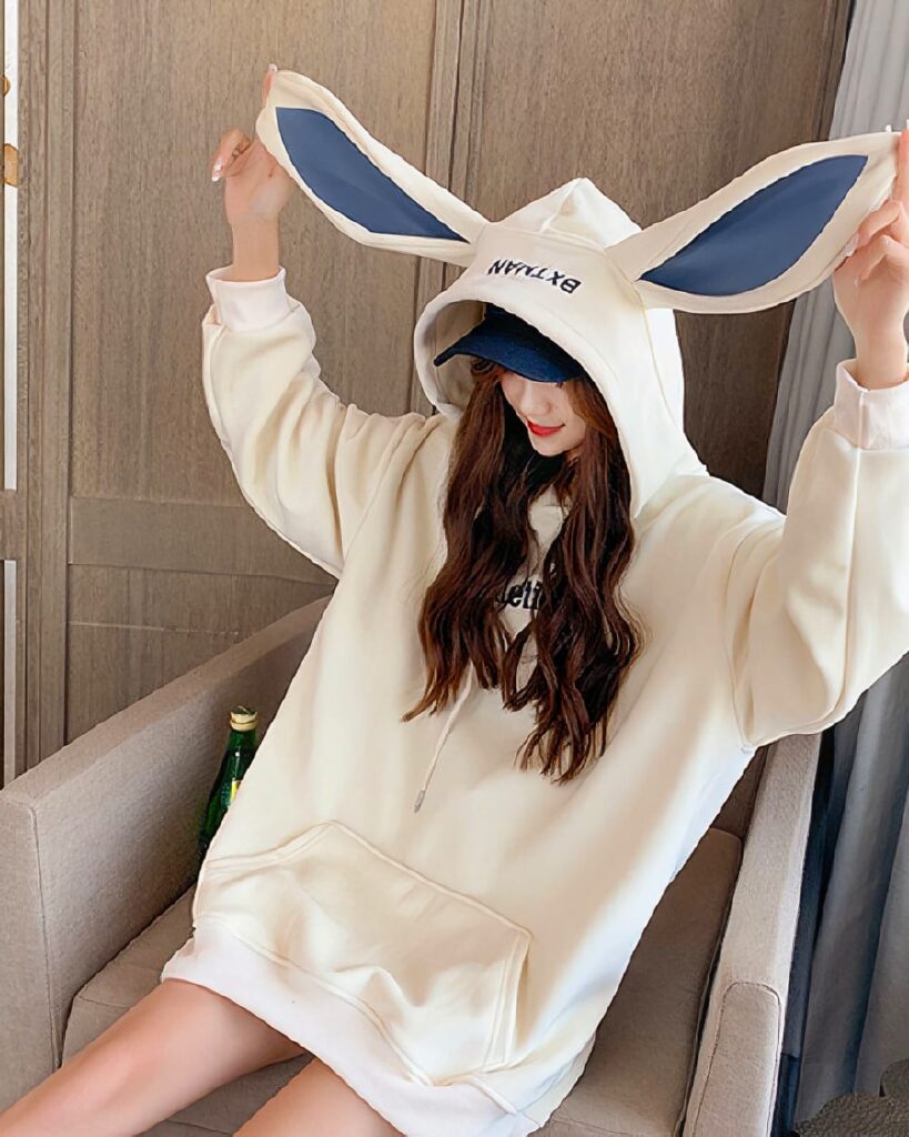 Cream-colored bunny ear hoodie with a hood, featuring plush ears and a relaxed fit.
