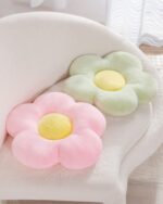 Kawaii thick flower seat cushion in pink and green, resting on a chair.