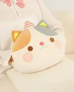Round animal hand warmer plushie, featuring a cat design with embroidered details.