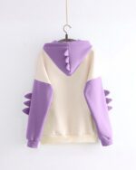 Dinosaur hoodie featuring a pastel color scheme and claw details on the hood and sleeves.