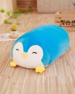 Blue animal mochi plushie, a penguin shape with closed eyes and a yellow beak.