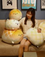 Several Kawaii melonwan plushies, resembling melon-shaped dogs, are displayed on a couch.