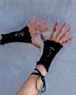Laced fishnet gloves, gothic aesthetic, black fingerless gloves with lace detailing.