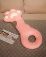 Cute Super Soft Cat Paw Sleeping Pillow displayed on a gray sofa.