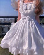 White gothic lolita dress with lace and layered ruffles.