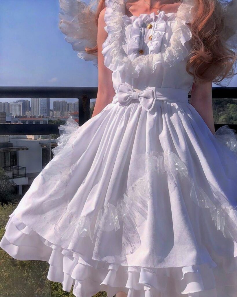 White gothic lolita dress with lace and layered ruffles.