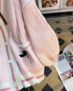 Pink and white striped kawaii bow sweater with button details.