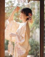 Woman wearing a Hanabi Pattern Summer Yukata dressing, featuring a traditional Japanese design.