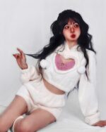 White kawaii fluffy pajamas set with a cutout design and pom-pom details, featuring a model.