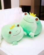 Kero the Queen and King Frog Plushie, two green plush frogs with crowns, resting on a bed.