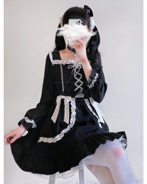 Black lace gothic lolita dress with puff sleeves and trim.