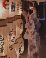 Light purple yukata worn by a person among Japanese paper lanterns.