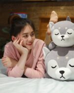 Close-up of a gray shiba and husky plushie, soft and cuddly, featuring stitched facial details.