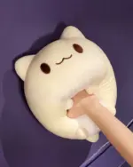 A beige round neko plushie with stitched eyes and mouth.
