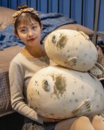 Kawaii Super Chonky Sea Lion Plushie resting on a bed with a child.
