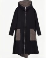 Black long hooded coat with a gray panel and zip closure. Harajuku outerwear.