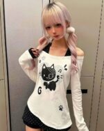 Patched Neko off-shoulder t-shirt featuring a cat graphic and paw prints. Long sleeve, cutecore style.