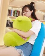 Kawaii animal mochi plushie, a green, plush toy with a rounded shape and a small pink dot.