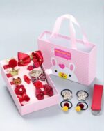 Kawaii diy material gift bag contents: hair accessories, bows, and embellishments inside a pink box.