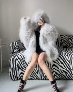 Grey puffy hooded coat worn by a person, winter fashion.