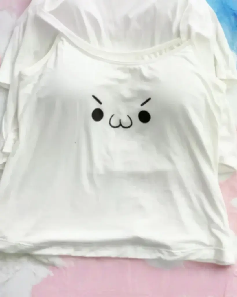 White cutecore aesthetic vest with a cute kaomoji print.