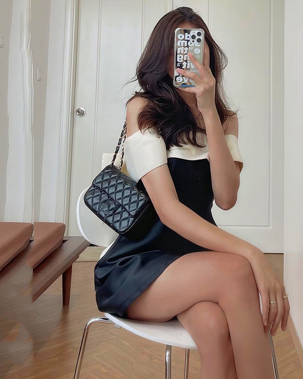 Black satin french aesthetic dress with a white collar and bow detail.