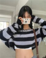 Black and white retro aesthetic sweater featuring a striped design and off-the-shoulder cut.