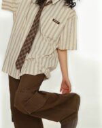 Vintage striped short sleeve shirt with a preppy aesthetic, styled with khaki pants and a tie.