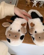 Close-up of The Cow Slippers, plush, spotted design for comfortable wear.