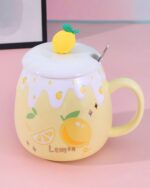 Yellow ceramic mug with lemon design and a lemon charm. Strawberry ceramic mug.