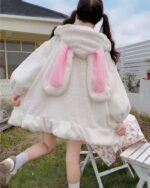 Fluffy bunny ears coat with hood, light beige color, plush material.