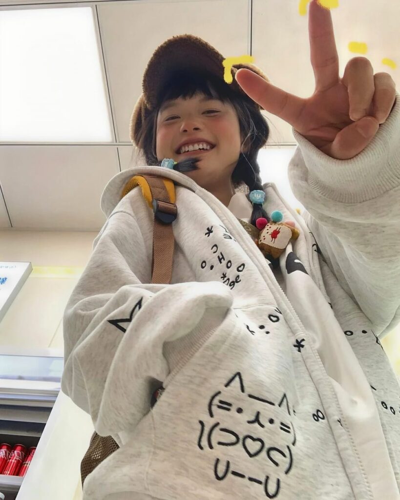 Y2K Kaomoji Hoodie featuring kawaii neko graphics on a white fleece pullover.