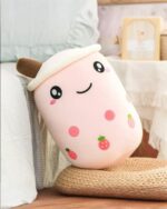 Pink boba milk tea plush toy with fruit accents and a straw.