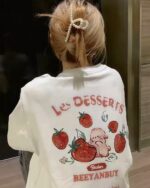 White strawberry bunny t-shirt with illustrated strawberries and a bunny design.