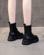 Black gothic over knee boots with a chunky sole and laces.