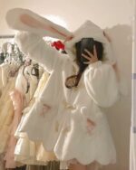 Fluffy rabbit ears hoodie on a hanger, kawaii clothing style.