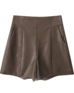 Brown vegan leather high waist shorts with a vintage aesthetic, featuring pleats and pockets.