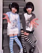 Two girls wearing a harajuku detachable sleeve shirt, striped socks, and accessories with a cutecore style.