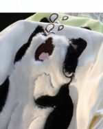 Close-up of a Japanese-style sleepy cat t-shirt featuring an embroidered feline design.