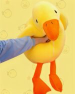 Close-up of Waddles and Puddles goose plush toy, a yellow stuffed animal with orange beak and legs.