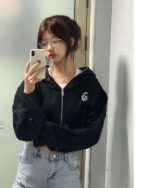 Black korean aesthetic hoodie worn by a woman, featuring a zip-up design and graphic print.